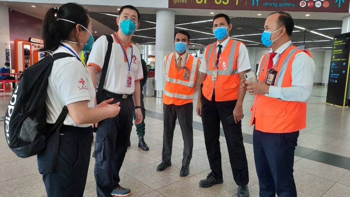 Members of a Chinese medical team are seen arriving at the airport in Phnom Penh, Cambodia, in April, to help conduct inspections amid new coronavirus protocols.