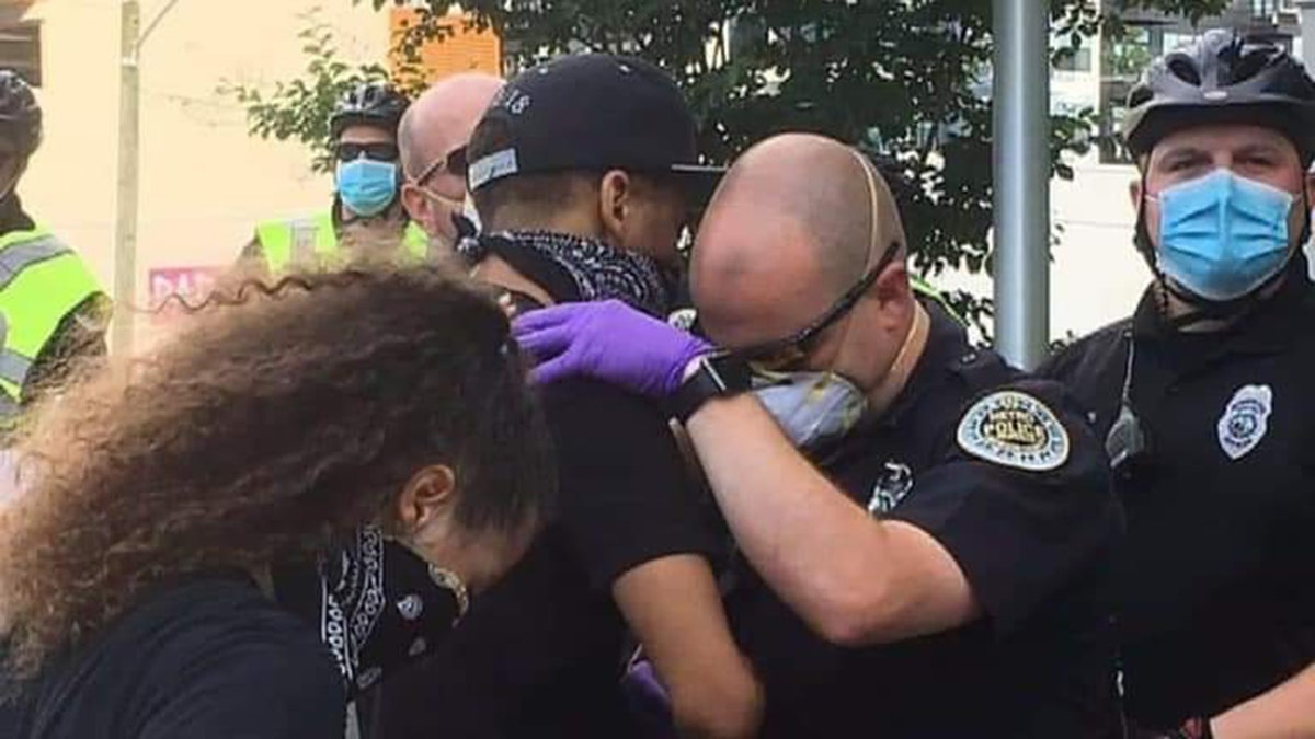 Nashville, Tenn. Officer Garren Hoskins prayed with a protester Saturday, May 30, 2020 during a peaceful protest.