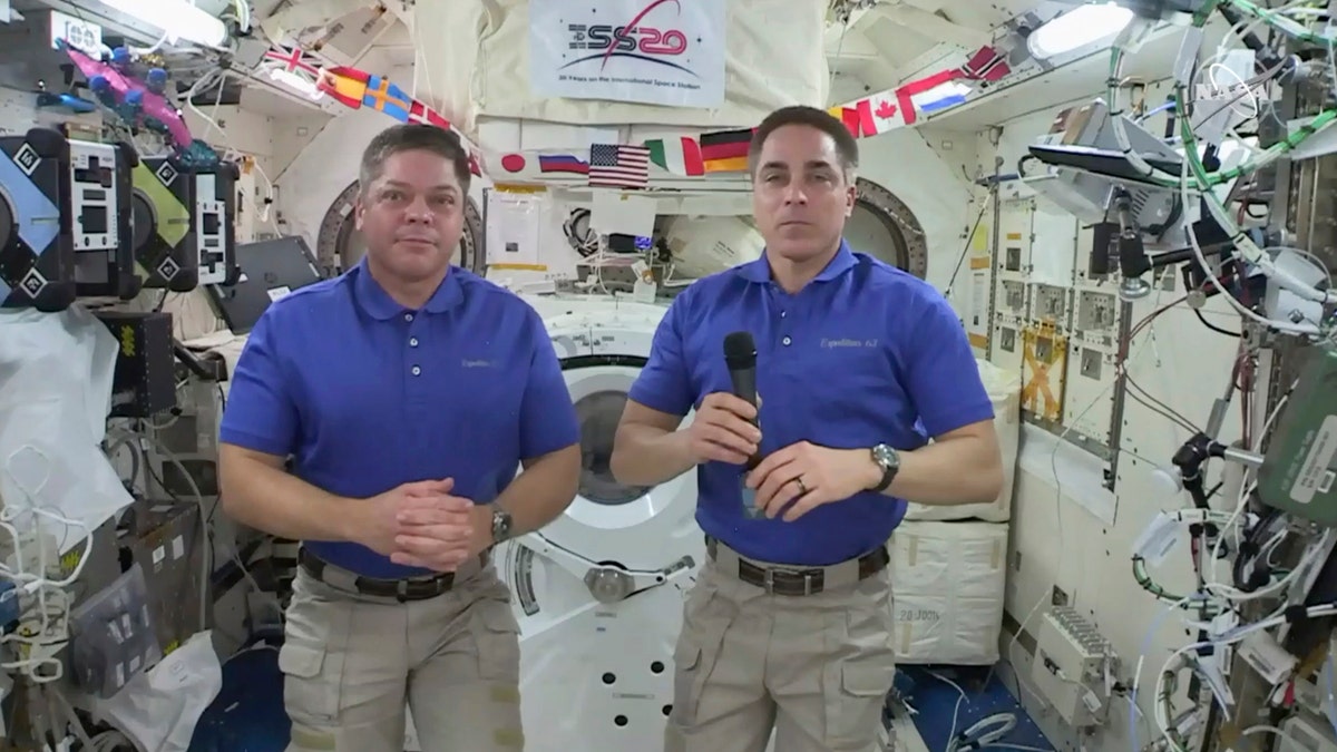 In this image taken from NASA video, NASA astronaut Chris Cassidy, right answers a question as fellow astronaut Robert L. Behnken listens during an interview aboard the International Space Station, Monday, June 29, 2020.