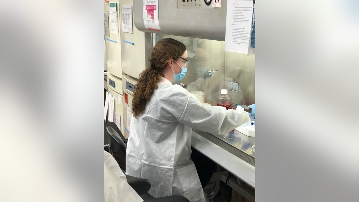 Christine Singer, vaccine research scientist at Pfizer, works on the vaccine under a laboratory fume hood. (Photo courtesy of Pfizer)