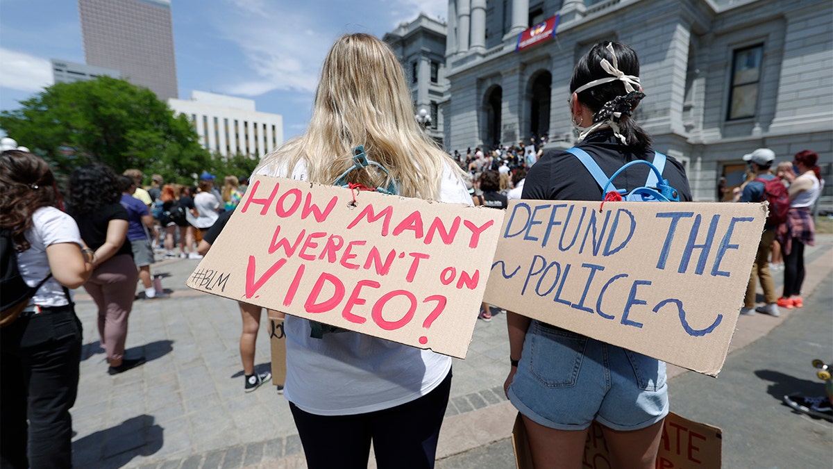 Demonstrators, with signs attached to their packs, gather outside the State Capitol in Denver, Tuesday, June 2, 2020, to protest the death of George Floyd, who died after being restrained by Minneapolis police officers on May 25. (AP Photo/David Zalubowski)