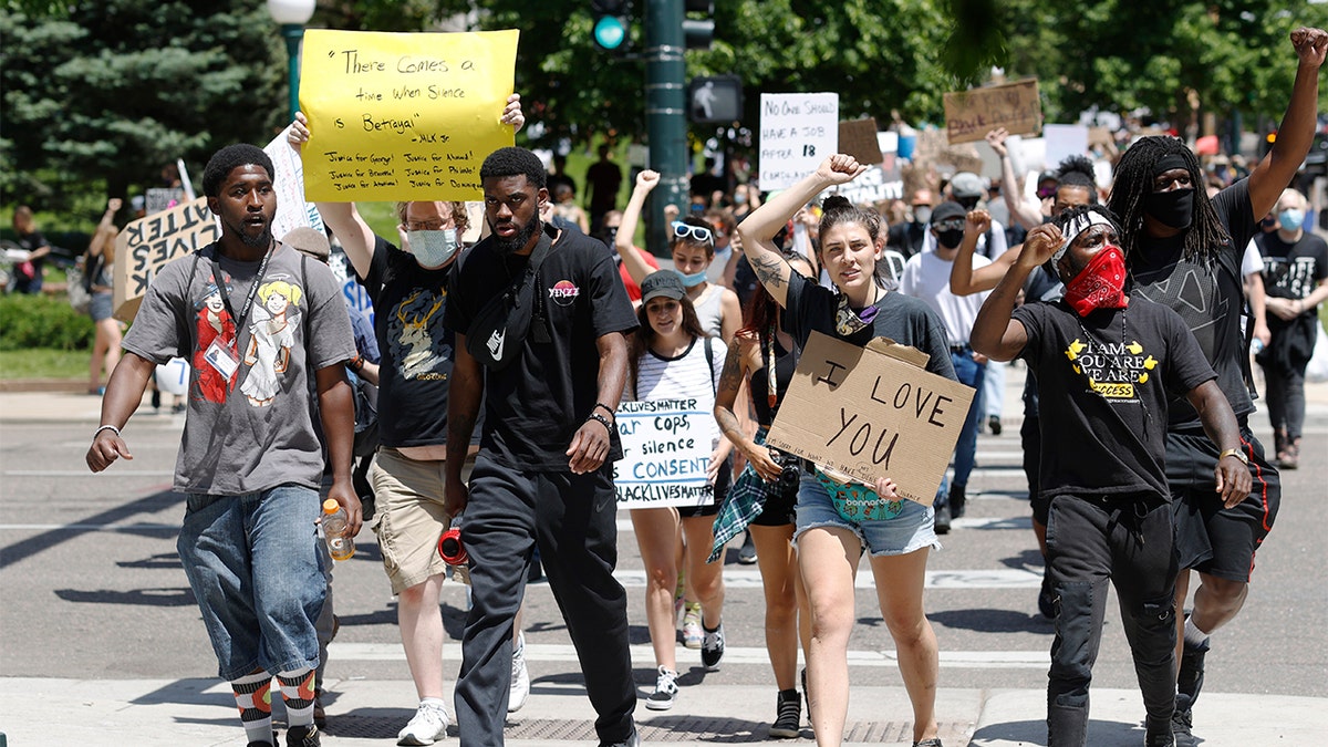 Demonstrators march from the State Capitol to nearby Civic Center Park during a protest over the death of George Floyd, a handcuffed black man who was died in Minneapolis police custody on May 25, Tuesday, June 2, 2020, in Denver. (AP Photo/David Zalubowski)