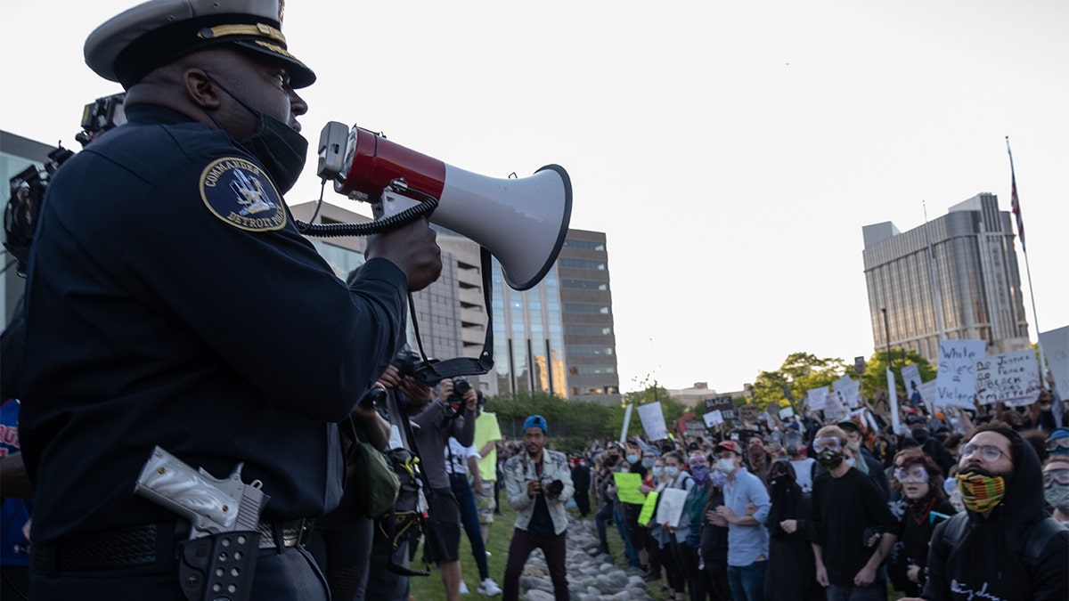 Police officers speaking to demonstrators in Detroit last May following a night of protests that saw several arrests and uses of tear gas by law enforcement. (SETH HERALD/AFP via Getty Images, File)
