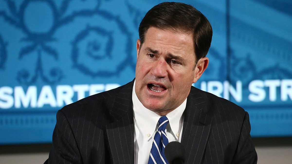 Arizona Republican Gov. Doug Ducey announces the latest coronavirus numbers and recent spike in cases during a news conference Thursday, June 11, 2020, in Phoenix. (AP Photo/Ross D. Franklin, Pool)