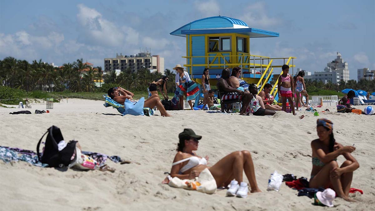 Beachgoers sunbathe as beaches are reopened with restrictions to limit the spread of the coronavirus disease (COVID-19), in Miami Beach, Florida, U.S., June 10, 2020.