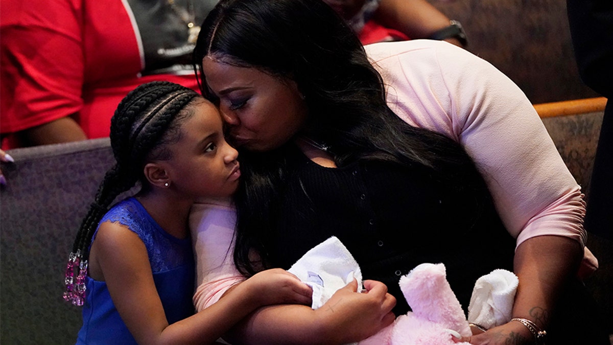 Roxie Washington holds Gianna Floyd, the daughter of George Floyd as they attend the funeral service for George Floyd at The Fountain of Praise church Tuesday, June 9, 2020, in Houston. (AP Photo/David J. Phillip, Pool)