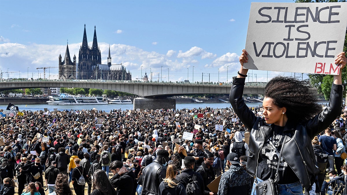 Thousands of people demonstrate in Cologne, Germany, Saturday June 6, 2020, to protest against racism and the recent killing of George Floyd by police officers in Minneapolis, USA. His death has led to Black Lives Matter protests in many countries and across the US. A US police officer has been charged with the death of George Floyd. (AP Photo/Martin Meissner)