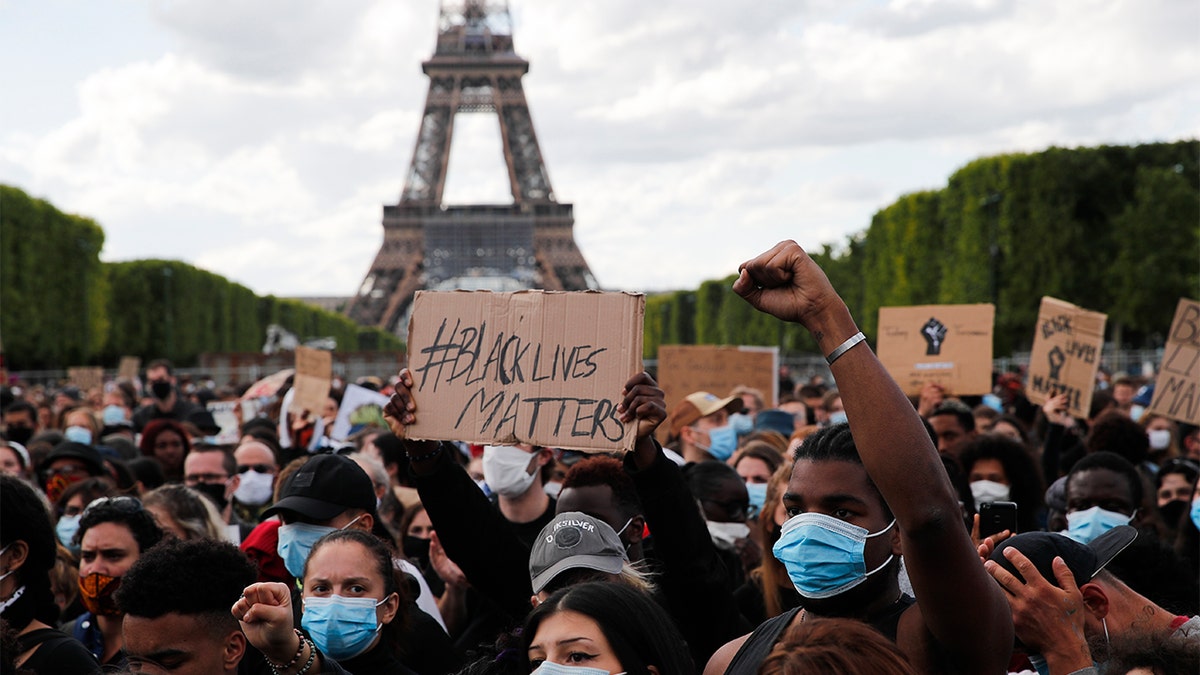 Hundreds of demonstrators gather on the Champs de Mars as the Eiffel Tower is seen in the background during a demonstration in Paris, France, Saturday, June 6, 2020, to protest against the recent killing of George Floyd, a black man who died in police custody in Minneapolis, U.S.A., after being restrained by police officers on May 25, 2020. Further protests are planned over the weekend in European cities, some defying restrictions imposed by authorities because of the coronavirus pandemic. (AP Photo/Francois Mori)