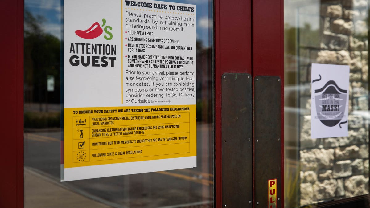 In this June 15 photo, a sign notifies customers of new regulations outside a Chili's Grill &amp; Bar restaurant in Syracuse, New York.