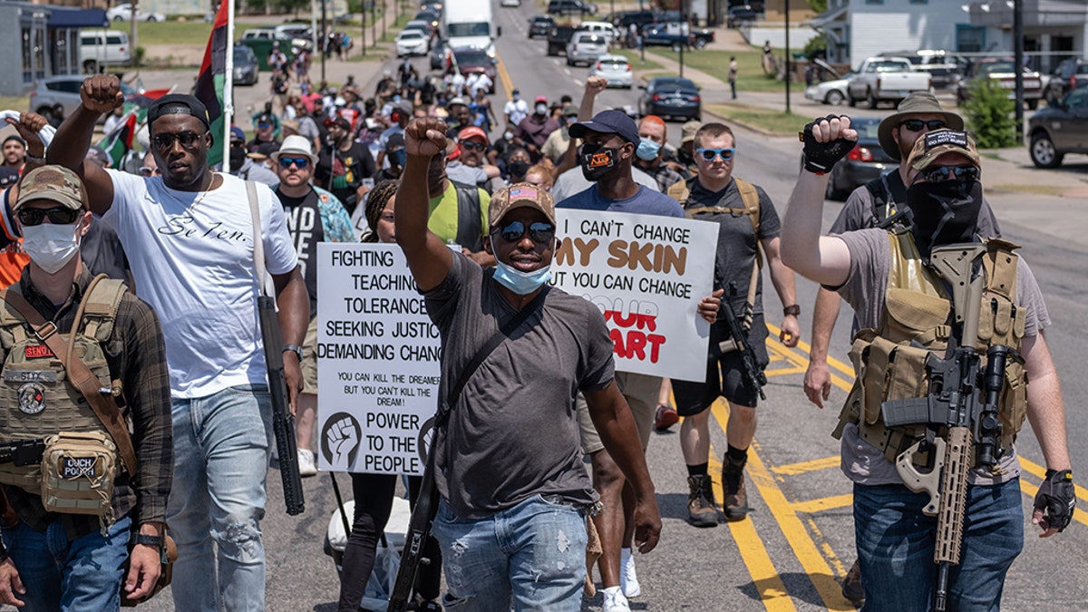 Black gun owners march to the governor's mansion in Oklahoma City on Saturday during a pro-second amendment rally on the same day that President Trump's holds his first political rally in months amid the coronavirus pandemic.