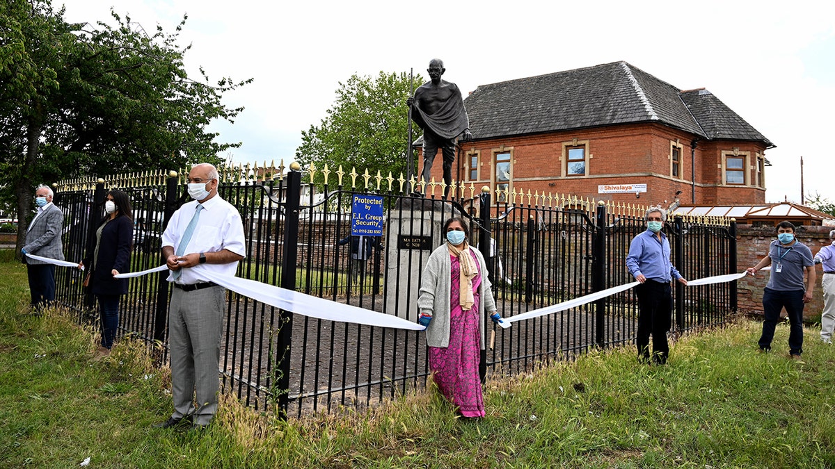 LEICESTER, UNITED KINGDOM - JUNE 13: Keith Vaz, the former Member of Parliament for Leicester West helps form a barrier around the statue of Mahatma Gandhi on June 13, 2020 in Leicester, United Kingdom. (Photo by Ross Kinnaird/Getty Images)