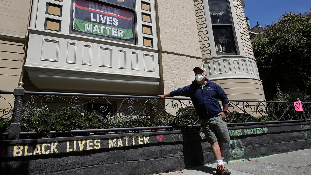 The CEO of a cosmetic company issued an apology Sunday after she and her husband confronted Juanillo and threatened to call police because he stenciled "Black Lives Matter" in chalk on his San Francisco property. (AP Photo/Jeff Chiu)