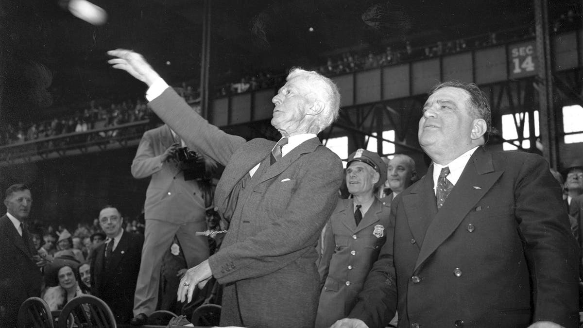 In this Oct. 1, 1941, file photo, Kenesaw Mountain Landis, baseball commissioner, throws out the first ball, formally opening the 1941 World Series featuring the Brooklyn Dodgers and the New York Yankees at Yankee Stadium, New York. (AP Photo)
