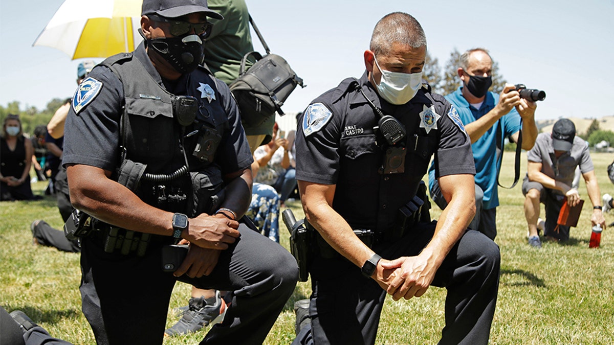 George Floyd protesters embrace taking a knee for race awareness