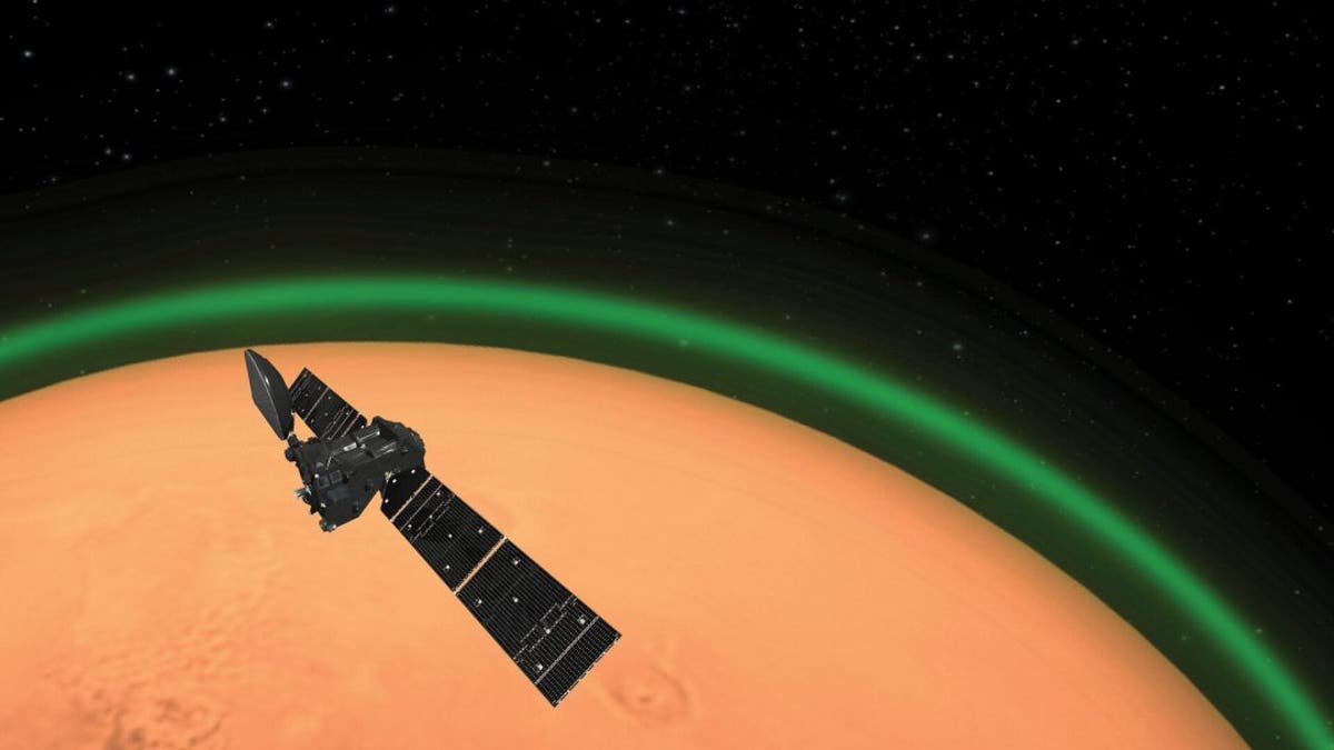Artist’s impression of ESA’s ExoMars Trace Gas Orbiter detecting the green glow of oxygen in the Martian atmosphere. This emission, spotted on the dayside of Mars, is similar to the night glow seen around Earth’s atmosphere from space. (Credit: ESA)