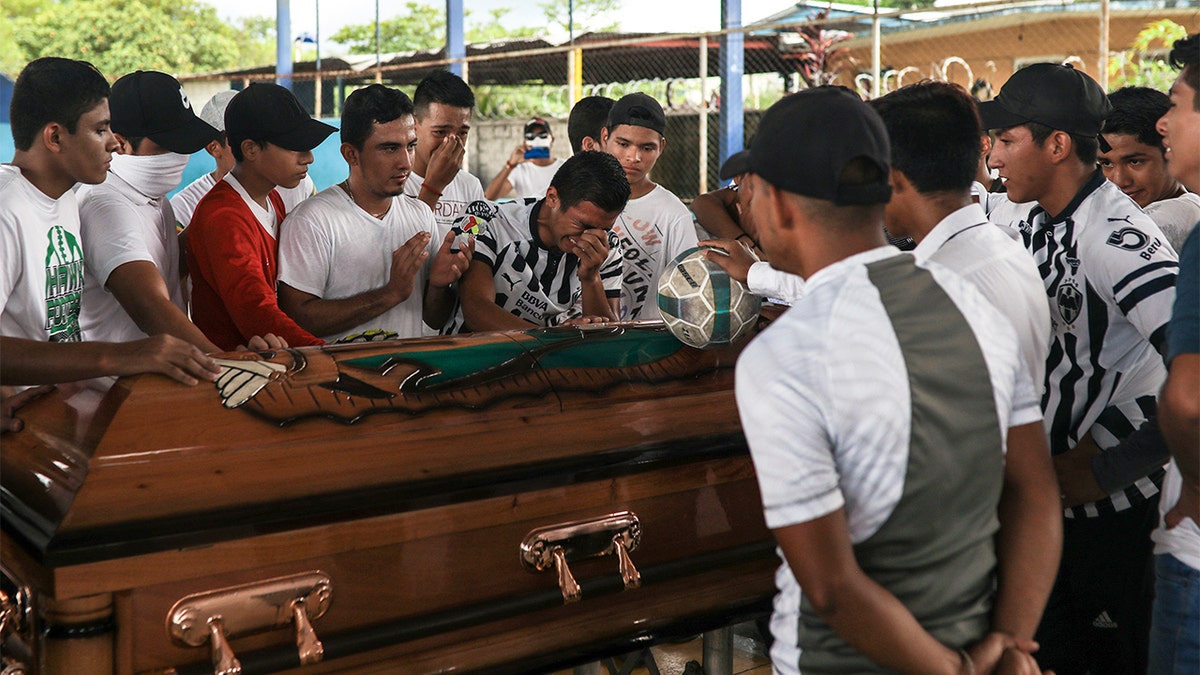 Alexander Martinez's family and friends mourn during his funeral in Acatlan de Perez Figueroa, Mexico, Thursday, June 11, 2020. Hundreds of residents of this town in southern Mexico bid farewell amid anger and tears to Alexander Martinez, a 16-year-old Mexican-American boy shot dead by local police. 