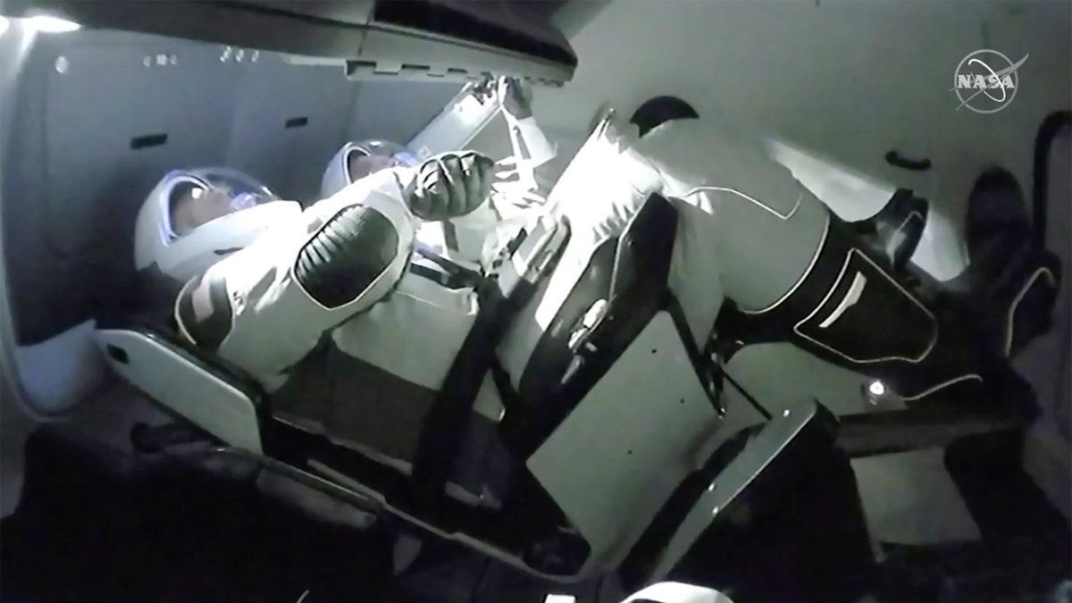 In this image taken from NASA TV video, the SpaceX Dragon crew capsule, with NASA astronauts Doug Hurley, left, and Robert Behnken aboard docks with the International Space Station Sunday, May 31, 2020.