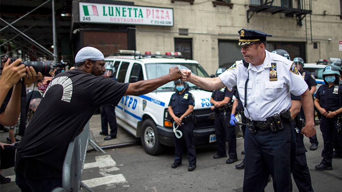 NYPD Deputy Police Chief McCarthy greets protesters as they take part in a solidarity march for George Floyd, Tuesday, June 2, 2020, in New York. Floyd, a black man died after being restrained by Minneapolis police officers on May 25.(AP Photo/Eduardo Munoz Alvarez)