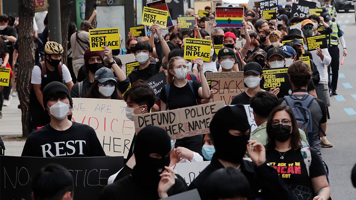 People march to protest during a solidarity rally for the death of George Floyd in Seoul, South Korea, Saturday, June 6, 2020. Floyd died after being restrained by Minneapolis police officers on May 25.(AP Photo/Ahn Young-joon)