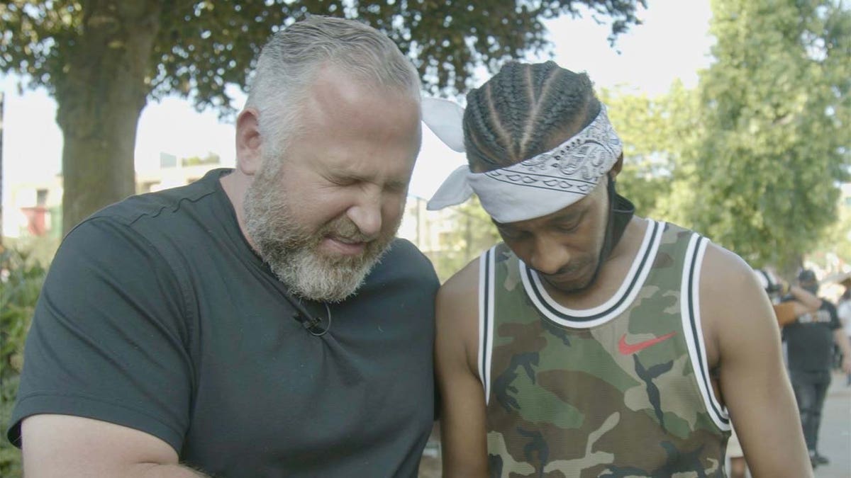 Pastor Brian Gibson, founder of the Peaceably Gather movement and His Church leader, prays with a Black Lives Matter protester near the CHOP zone in Seattle.