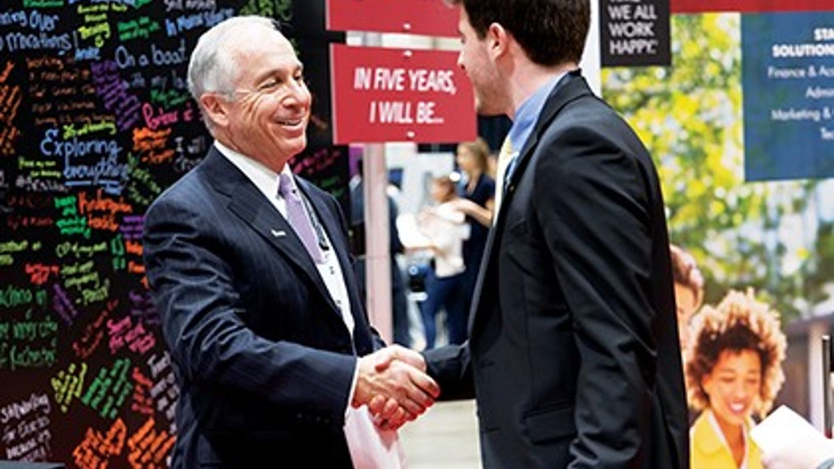 Paul McDonald, senior executive director at Robert Half, greeting a student at an Enactus event. He's been speaking with college grads throughout this time about the current environment and providing tips and tactics for what they should be considering as they enter the job market.