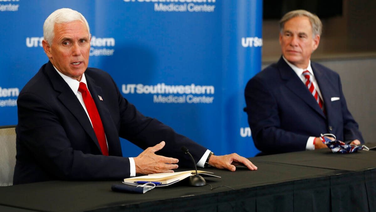 Vice President Mike Pence makes remarks as Texas Gov. Greg Abbott looks on during a news conference after Pence met with Abbott and members of his healthcare team regarding COVID-19. (AP Photo/Tony Gutierrez)