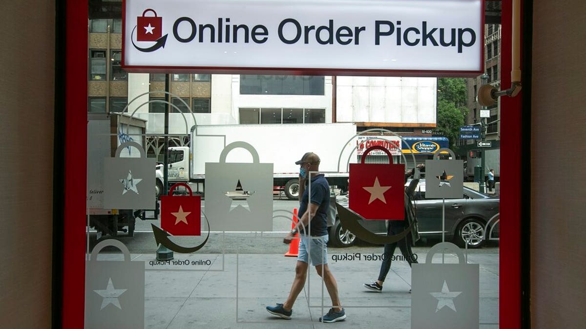 Pedestrians pass the online order pickup area at the Macy's Herald Square location Friday, June 19, 2020, in New York. New York City hits a key point Monday in trying to rebound from the nation’s deadliest coronavirus outbreak. (AP Photo/Frank Franklin II)