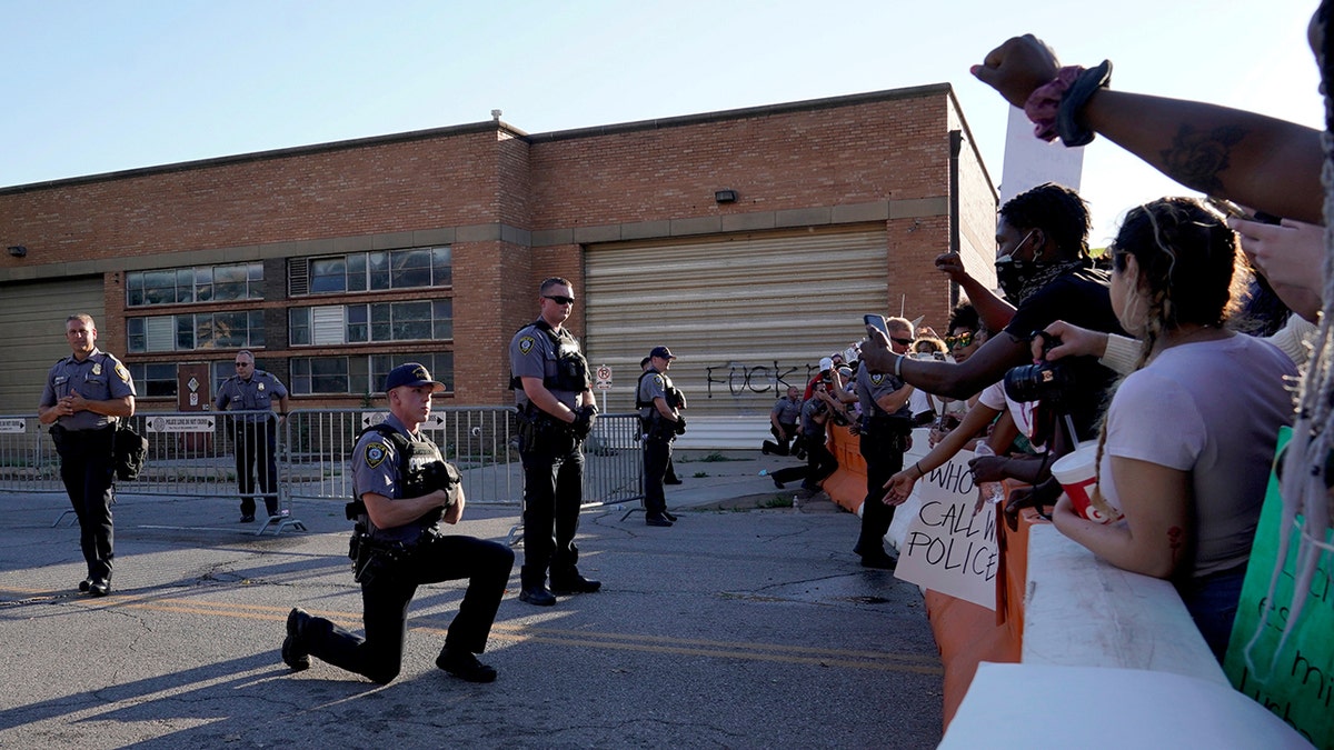 A single officer takes a knee in solidarity with protesters during nationwide unrest following the death in Minneapolis police custody of George Floyd, outside the Oklahoma City Police Department in Oklahoma City, Oklahoma, U.S., May 31, 2020. (Reuters/Nick Oxford)