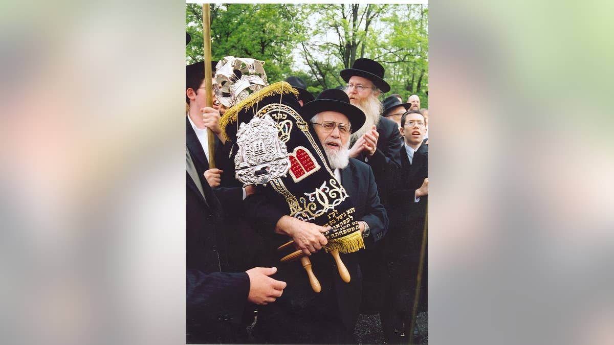 Rabbi Simcha Shafran, father of Rabbi Avi Shafran, carrying a Torah donated to a Baltimore synagogue.