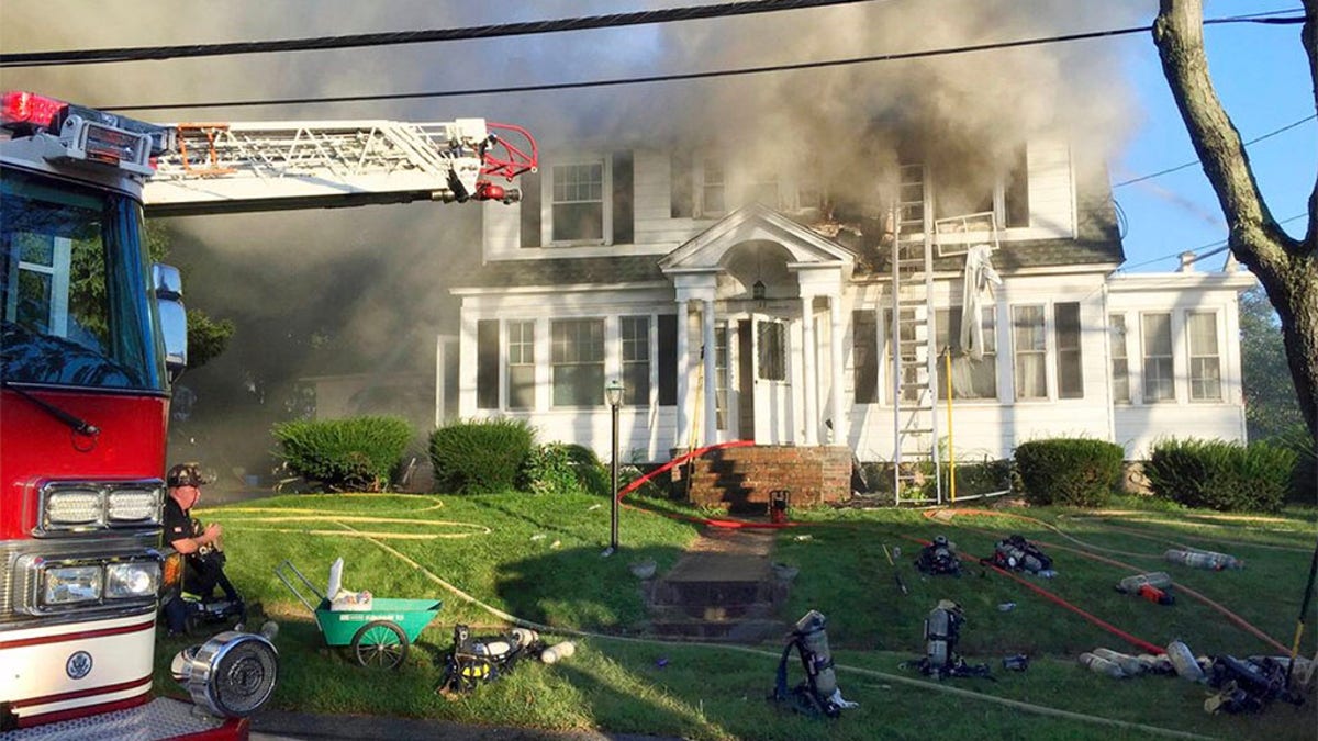 Firefighters battle a house fire in North Andover, Massachusetts, as one of multiple emergency crews responding to a series of gas explosions and fires triggered by a problem with a gas line that feeds homes in several communities north of Boston. (AP Photo)
