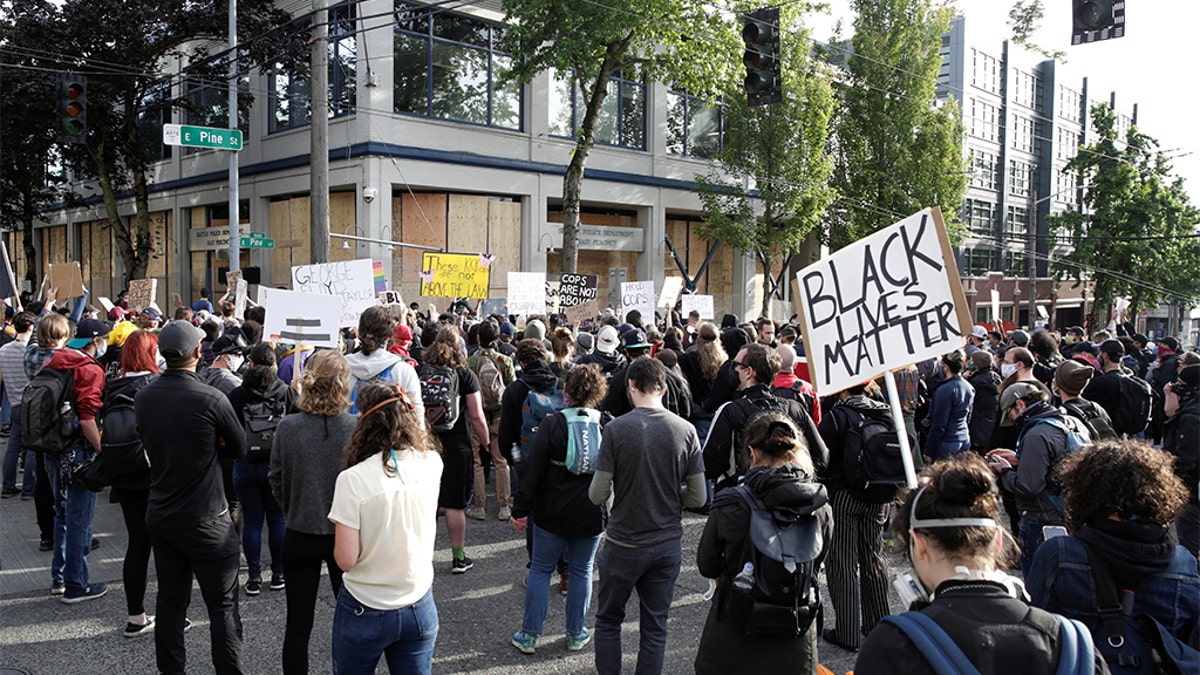 Protesters demonstrate outside the Seattle Police Department's East Precinct after the building was boarded up and vacated and people continue rally against racial inequality and the death in Minneapolis police custody of George Floyd, in Seattle, Washington, U.S. June 8, 2020. (REUTERS/Jason Redmond)