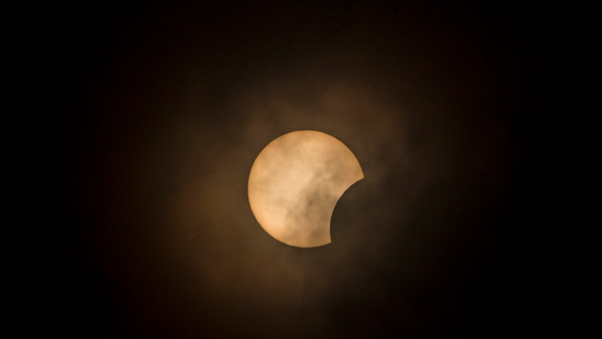 A partial solar eclipse is visible in the Banda Aceh sky, Indonesia, June 21, 2020.