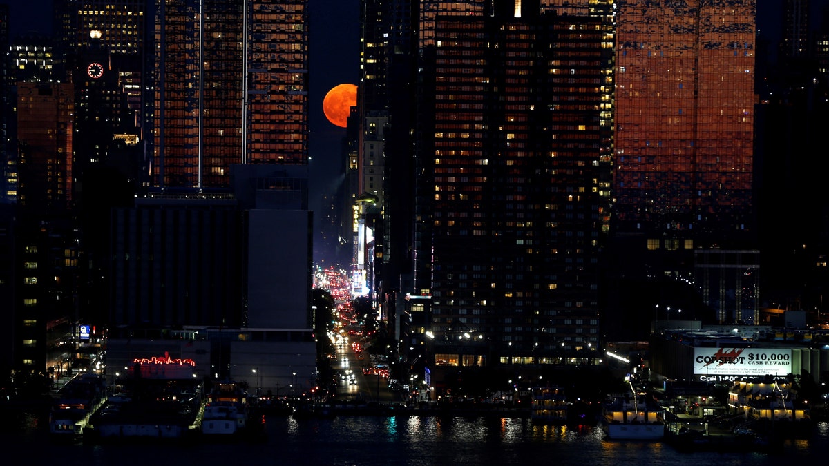 A full moon known as a strawberry moon rises over 42nd Street in New York, United States on June 28, 2018 - file photo.