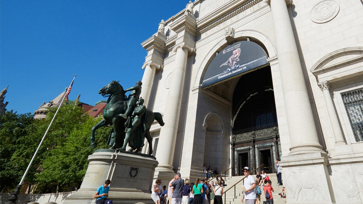 American Museum of Natural History building facade and Theodore Roosevelt statue with people in a sunny day, clear blue sky on Sept. 13, 2016 in New York City. 