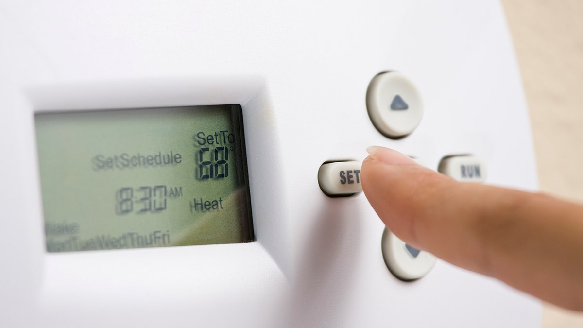 Person setting the thermostat
