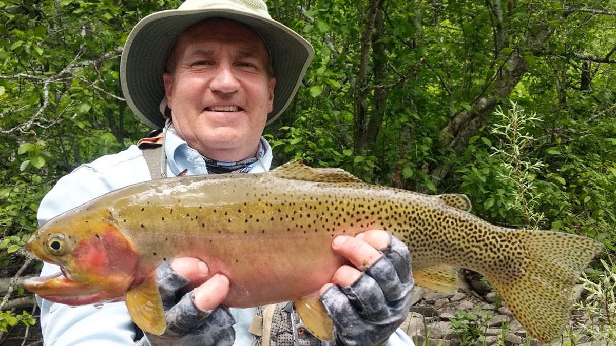 Tom Weadick with his record-breaking, 21-inch Westslope cutthroat trout.