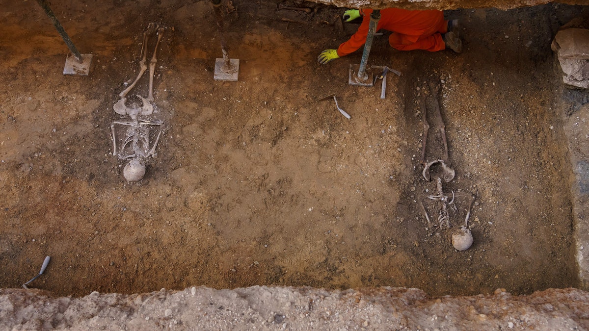 An archaeologist works in an excavation carried out by the Hispano-Irish Association in a ruined chapel in Valladolid - May 28, 2020.