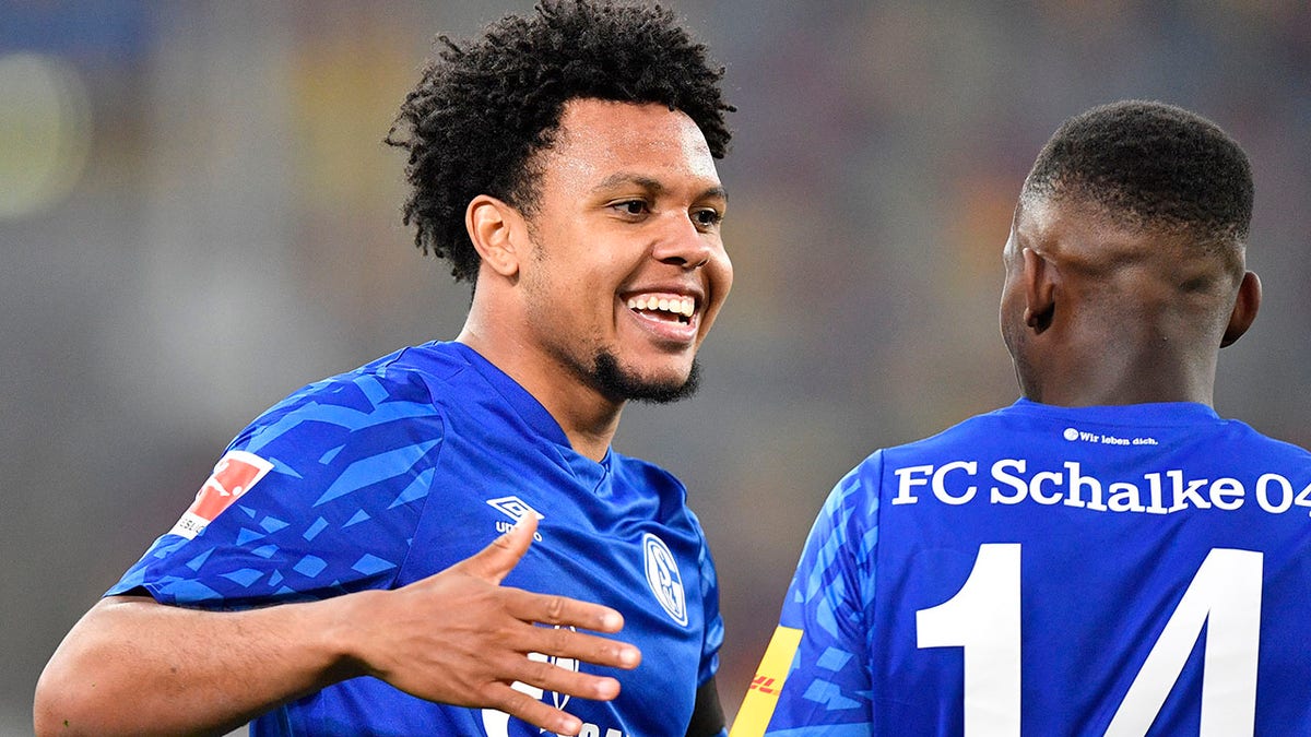 Schalke's Weston McKennie, left, celebrates with Schalke's Rabbi Matondo after scoring his side's opening goal during the German Bundesliga soccer match between Fortuna Duesseldorf and FC Schalke 04 in Duesseldorf, Germany, Wednesday, May 27, 2020. (AP Photo/Martin Meissner, Pool)
