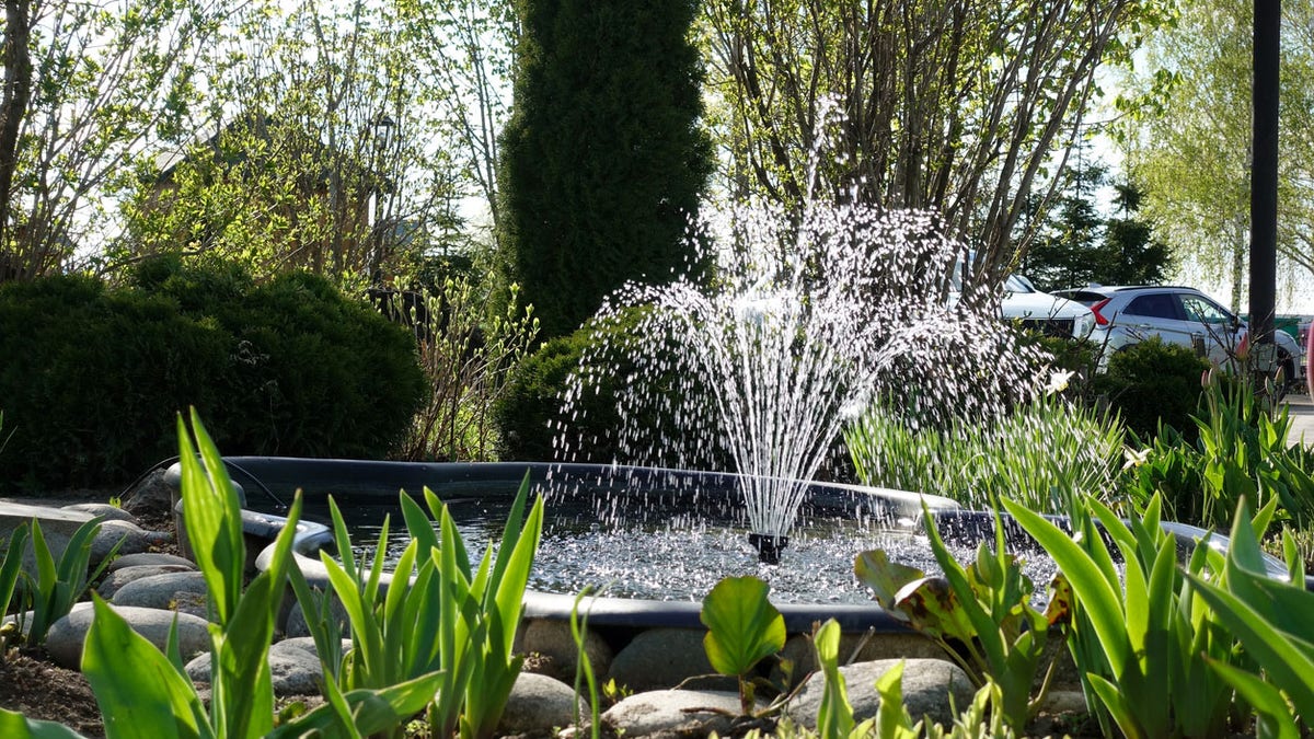 A small fountain in the garden. Garden architecture
