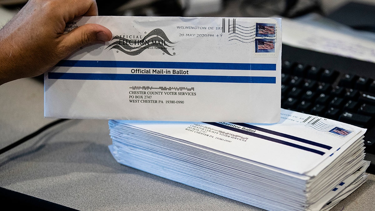 FILE - In this May 28, 2020, file photo, Dave Turnier processes mail-in ballots at at the Chester County Voter Services office in West Chester, Pa., prior to the primary election. The civic ritual of casting a ballot has been disrupted by a global pandemic and dramatically animated by social unrest. And If the results of a frustrating, chaotic primary in Georgia are a measure, the notion of democracy itself will also be on the ballot in the November election. Congress is now considering sending $3.6 billion to states to help facilitate safe and fair elections as part of another round of relief funds to recover from the coronavirus pandemic. (AP Photo/Matt Rourke, File)