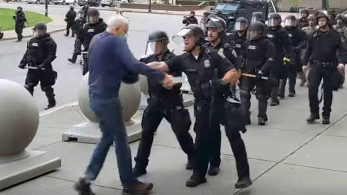 In this image from video provided by WBFO, a Buffalo police officer appears to shove a man who walked up to police June 4, in Buffalo, N.Y.