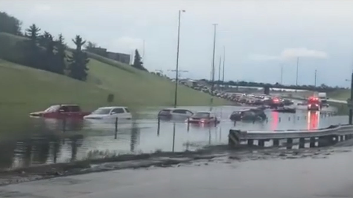 Torrential rain flooded roadways in the Calgary area late Saturday, stranding some drivers.