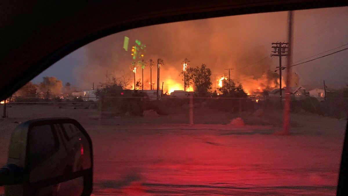 This June 28 photo provided by El Centro Fire Department shows a wildfire burning through an section of Niland, Calif.