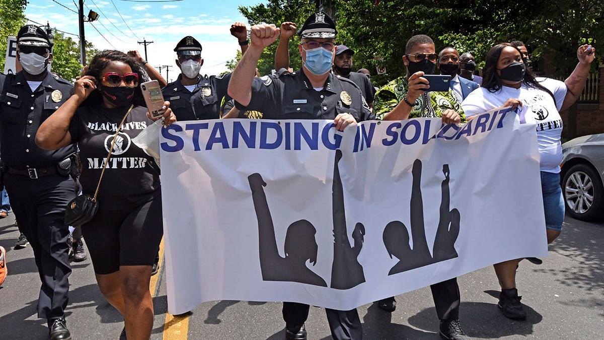 Wysocki, center, raises a fist while marching with Camden residents and activists in Camden, N.J., to protest the death of George Floyd in Minneapolis. (April Saul via AP)