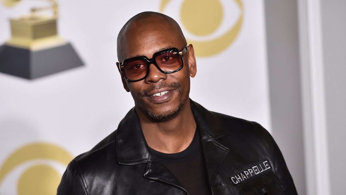 FILE - In this Jan. 28, 2018 file photo, Dave Chappelle poses in the press room with the best comedy album award for "The Age of Spin" and "Deep in the Heart of Texas" at the 60th annual Grammy Awards in New York. Chappelle celebrated George Floyd’s life and ripped the media for the way it handled his death in a surprise Netflix special. The special was released Thursday and is streaming free on Netflix’s comedy YouTube channel. (Photo by Charles Sykes/Invision/AP, File)