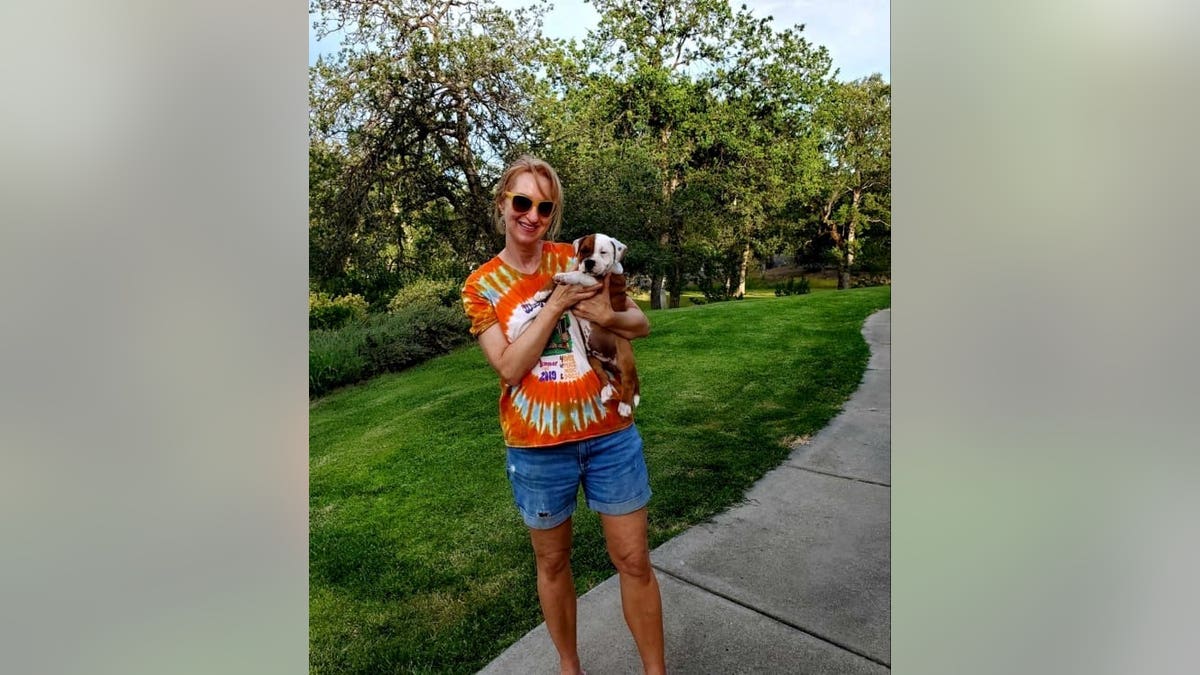 Corrinne Minnard with Elvis the Staffordshire bull terrier puppy. (Credit: SWNS)