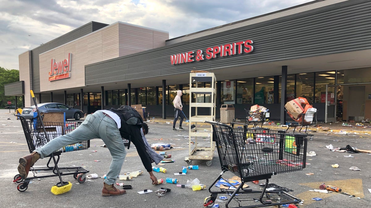 People clean up items outside a Jewel grocery store Monday in Chicago, after the business was broken into during unrest in reaction to the death of George Floyd. (AP)