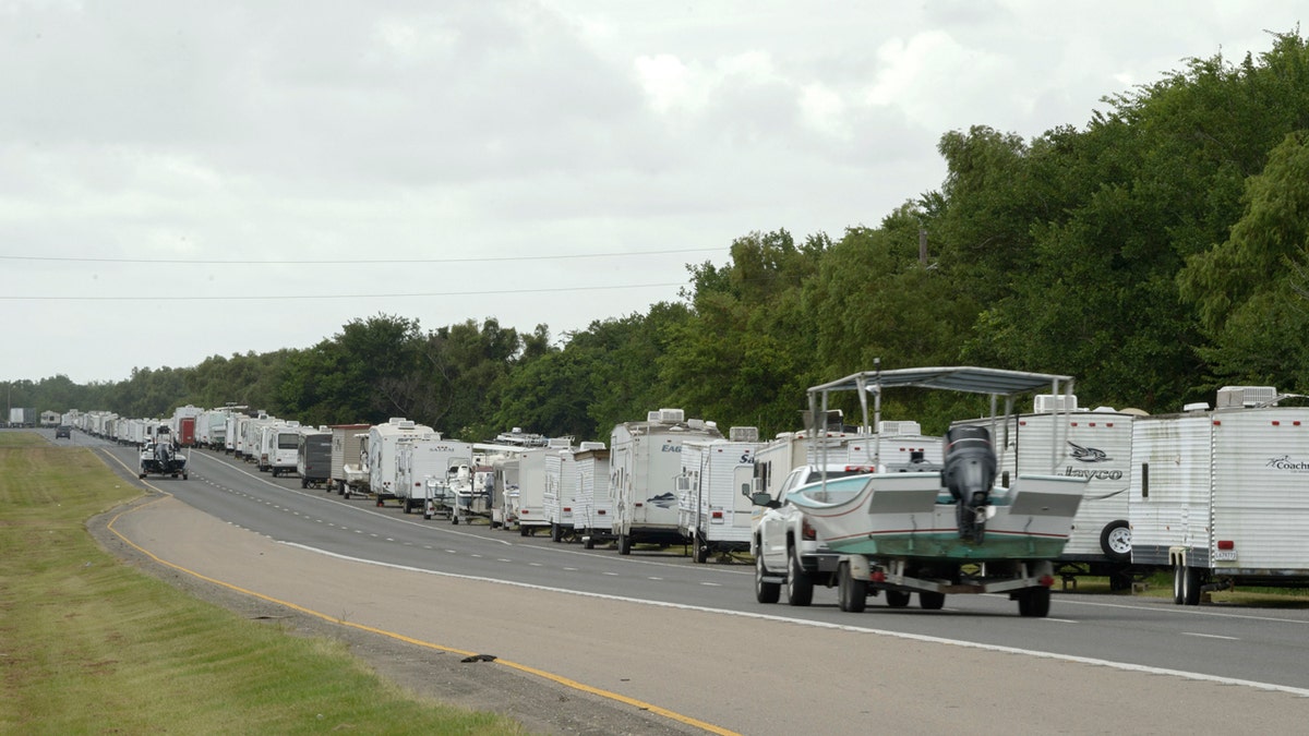 Recreational trailers and boats are parked along LA-46 inside the levee gates in anticipation of Tropical Storm Cristobal in St. Bernard Parish, La., Saturday, June 6, 2020.