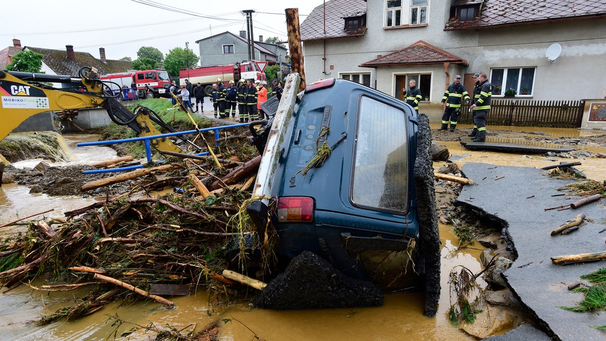 A car is trapped in a flooded area in Brevenec, the part of the village of Sumvald in the Olomouc region, Czech Republic, Monday, June 8, 2020.