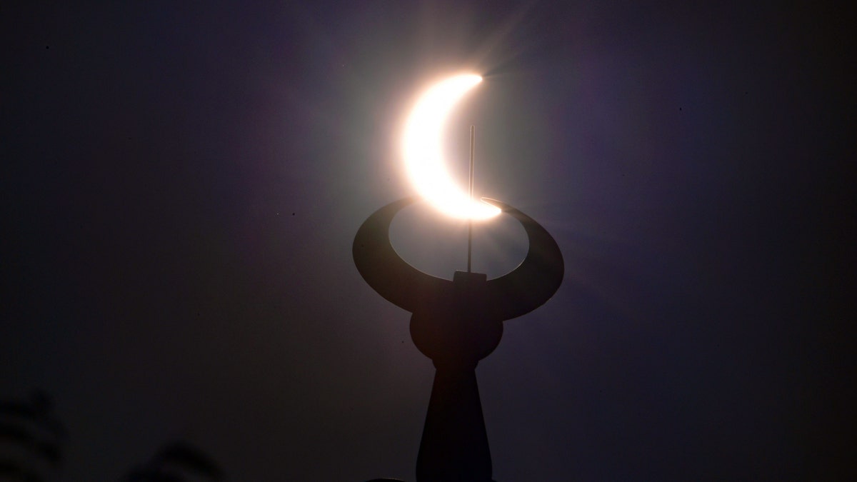 The moon partially covers the sun during an annular solar eclipse as seen from the Gulf emirate of Dubai, early on June 21, 2020.